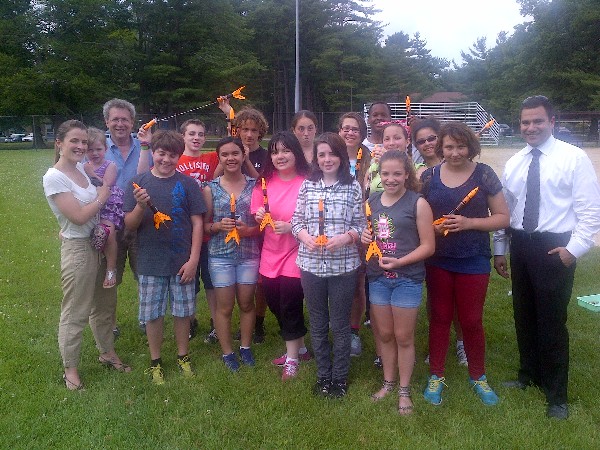 Kate Stowe (front row, far l), chapter vice president for Young AFCEAN affairs, and Matt Deutsch (front row, far r), Rocket Day program coordinator, join Hanscom Air Force Base Middle School’s 7th grade